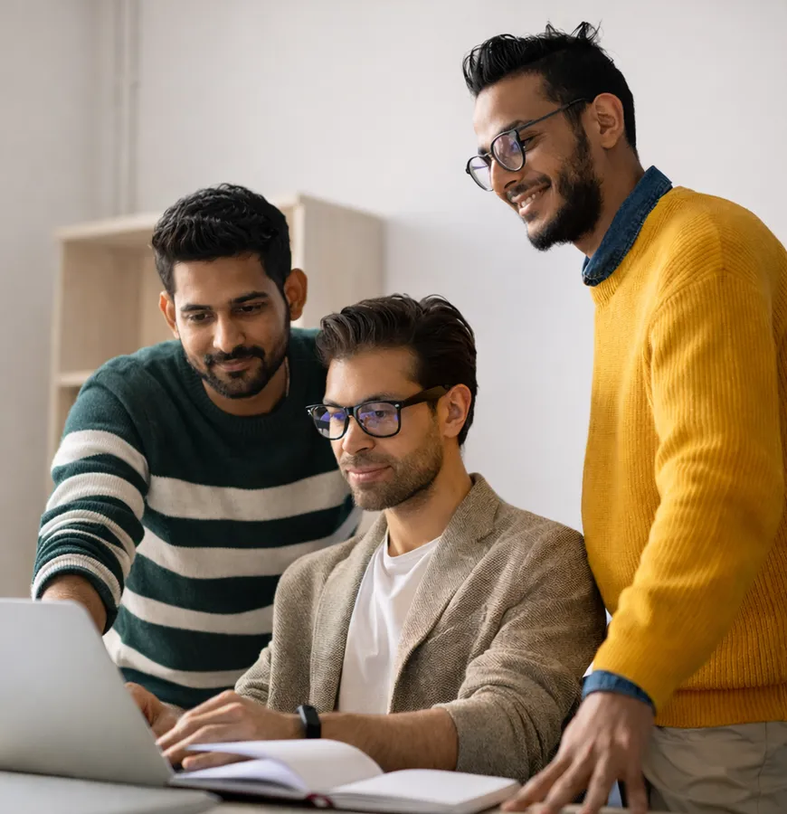 Team collaborating around computer